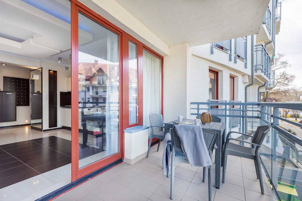 Furnished balcony with green surroundings. 