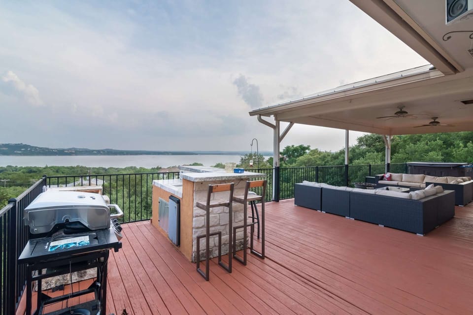 Upper deck off the main level has outdoor kitchen, lots of seating, and hot tub