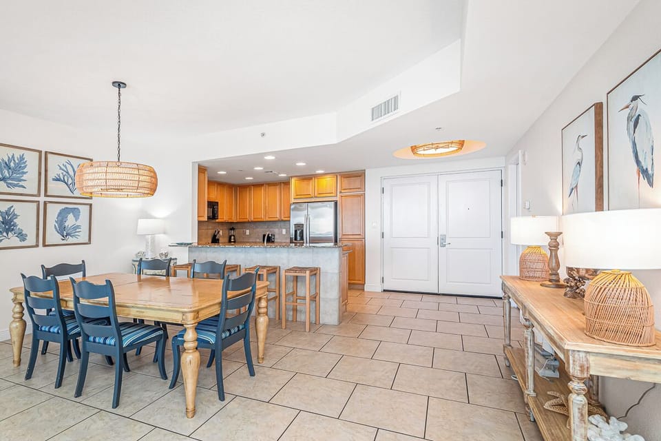 Your coastal retreat features an open dining and kitchen space with nautical charm, perfect for gathering with loved ones over home-cooked meals.