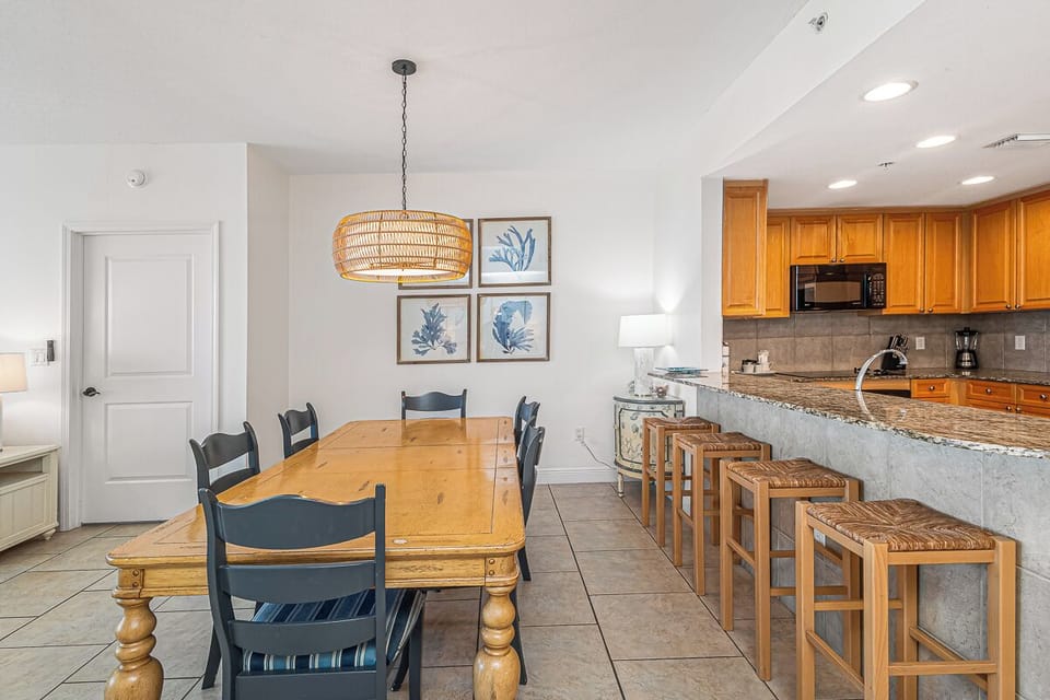 Gather around the warm wood dining table or chat at the granite breakfast bar in your fully equipped kitchen.