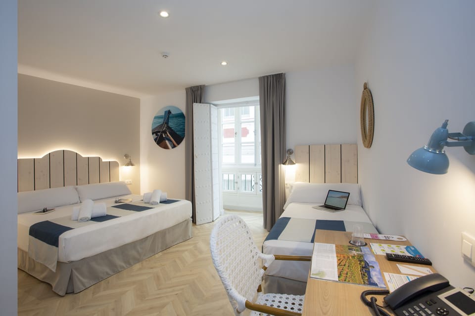 Triple Room, Balcony | Desk, laptop workspace, blackout drapes, iron/ironing board