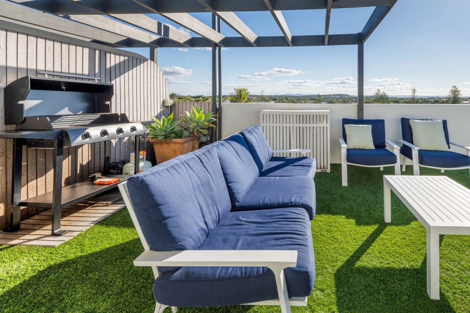 Private terrace with seating area, BBQ & views over Moffat Beach.