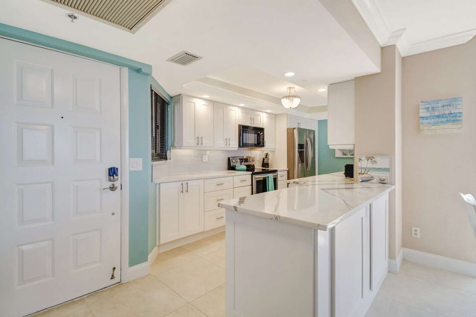 The kitchen is finished with upgraded appliances, beautiful cabinets, quartz counters and glass tile backsplash.
