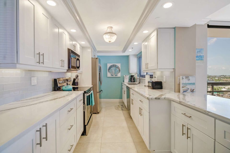 The kitchen is finished with upgraded appliances, beautiful cabinets, quartz counters and glass tile backsplash.