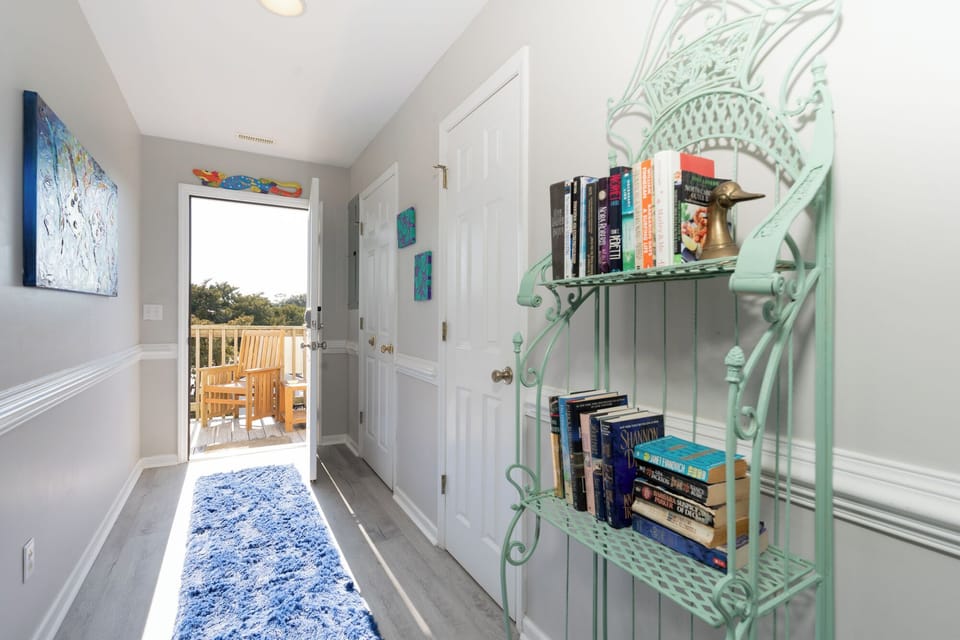 Browse books from your charming mint-green bookshelf before stepping onto your private balcony for morning coffee.