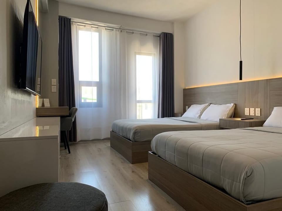 Comfort Quadruple Room | Down comforters, pillowtop beds, desk, laptop workspace