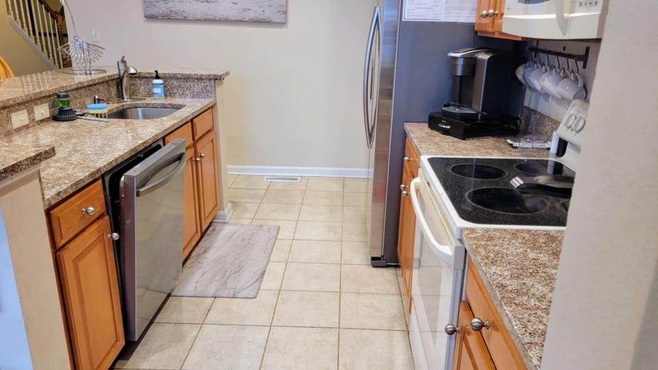 well stocked kitchen with all appliances and extra refrigerator in garage