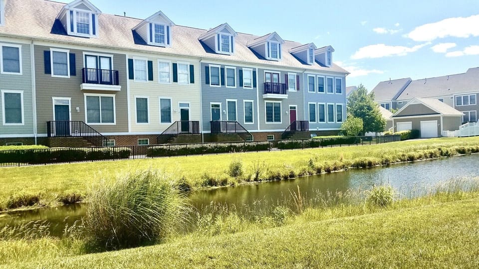 Front of home with pond views