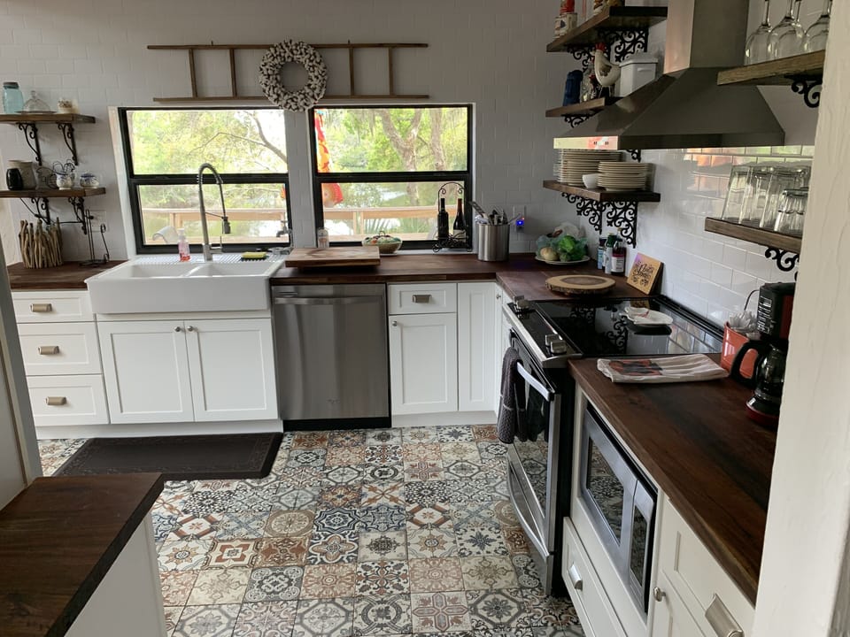Entry to decorative tiled kitchen floor with butcher countertops
