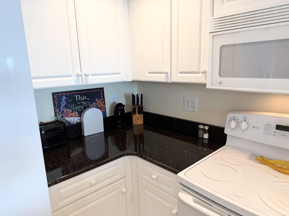 Bright, modern kitchen with sleek black countertops and ample storage