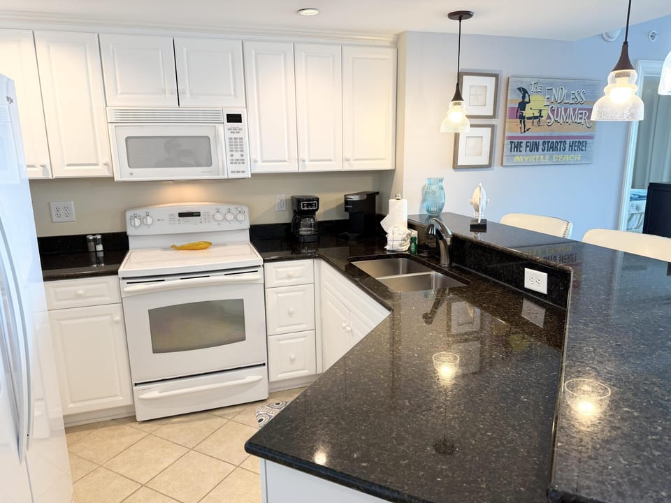 Bright, modern kitchen with sleek granite countertops and breakfast bar