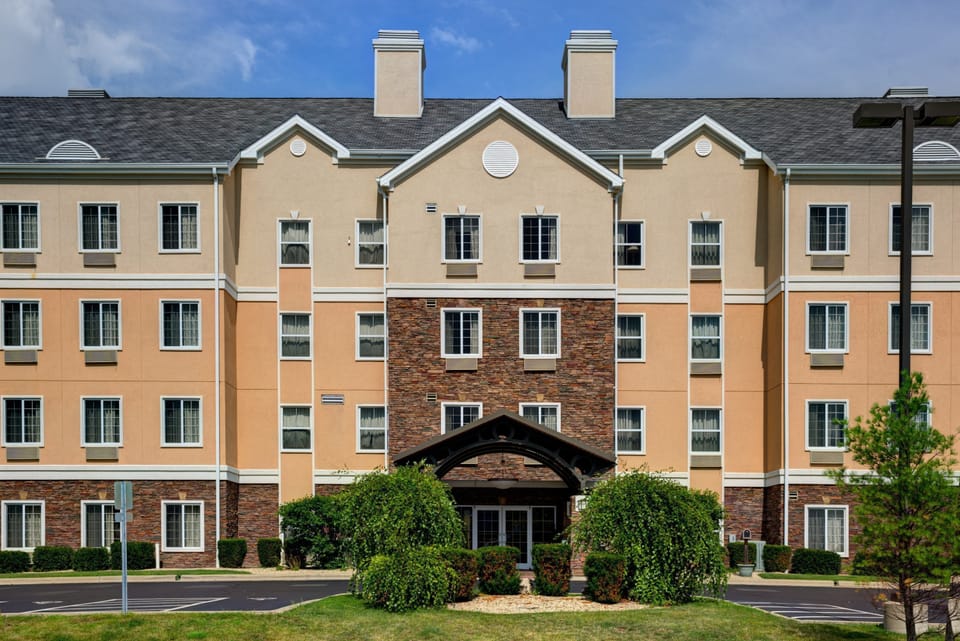 Multi-story hotel exterior with landscaped grounds.