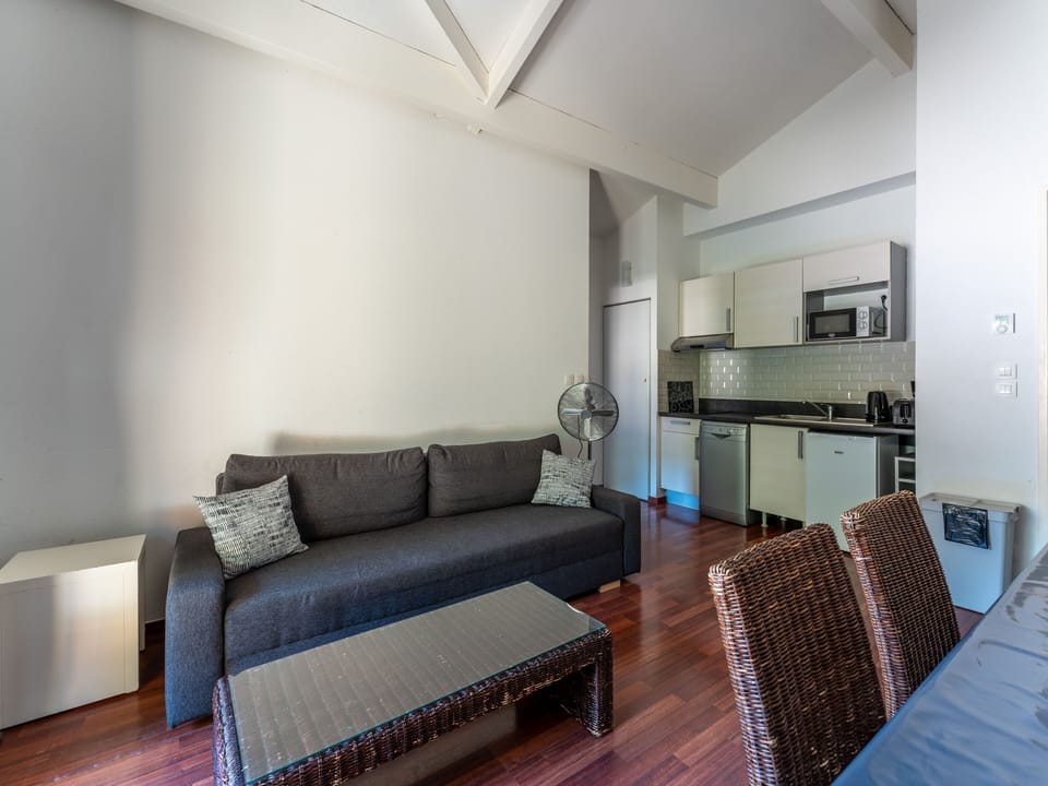 A wider view of the open-plan living space across multiple levels — generous, airy and full of the relaxed character that makes this triplex apartment a favourite for families.
