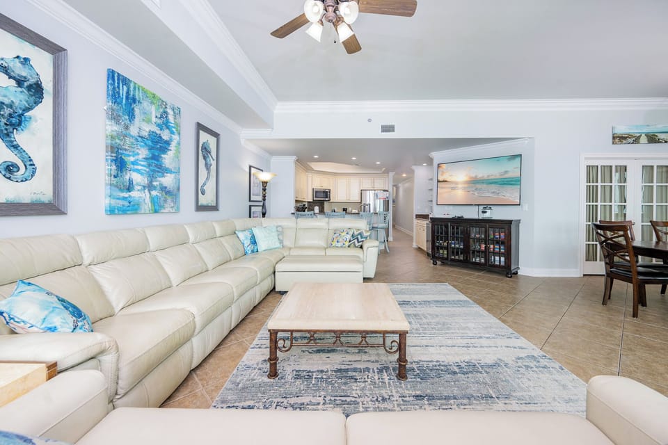 Relax on the cozy sofa with a queen sleeper in this inviting family room with breathtaking beachfront views