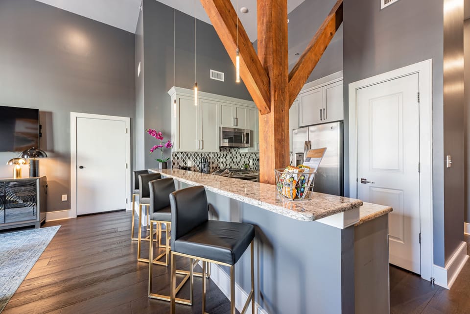 Cook and dine easily in the fully stocked kitchen, equipped with all stainless steel appliances, gas range, basic cookware, and a dining area for a comfortable meal at home. Entertain at the bar with seating for four.