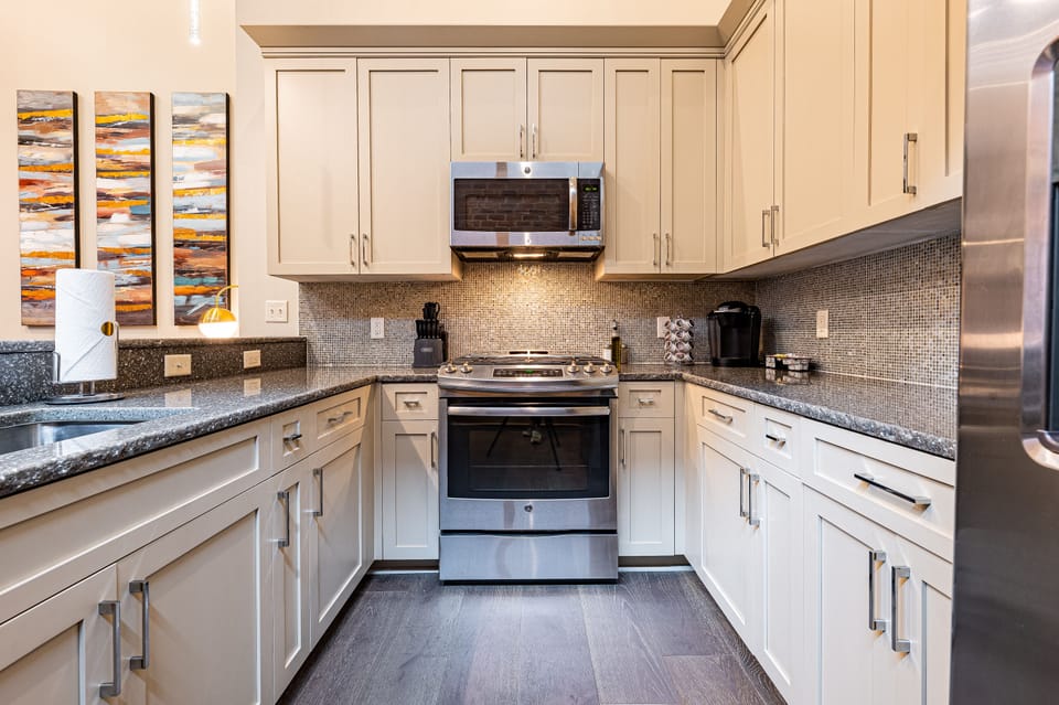 Cook and dine easily in the fully stocked kitchen, equipped with all stainless steel appliances, gas range, basic cookware, and a dining area for a comfortable meal at home. Entertain at the bar with seating for four.