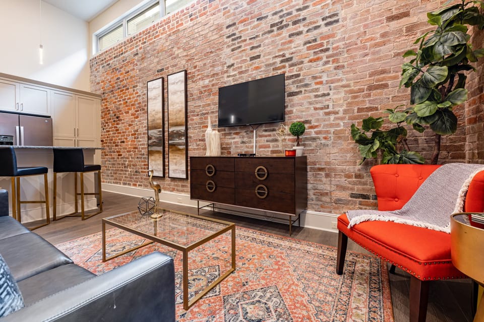 Open-concept living and kitchen area with comfortable seating options for you and your guests. Enjoy a 50” Samsung Smart 4K TV with streaming and DIRECTV Entertainment. The living room also features a queen-size sleeper sofa for extra guests.