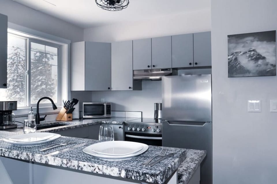 The modern kitchen with granite countertops.