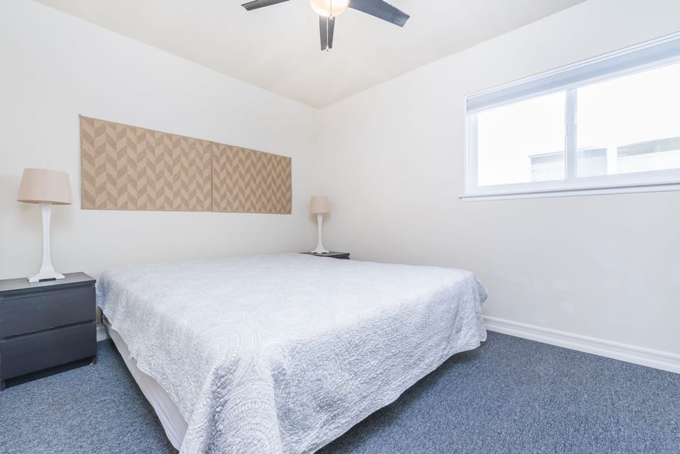 Fourth bedroom outfitted with King bed, linens, ceiling fan and closet. Located along central hallway.
                