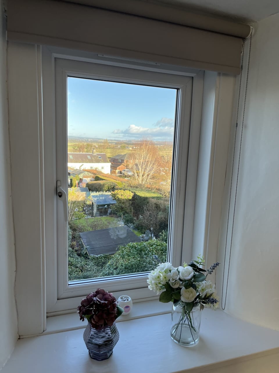 Open country view from rear window of bedroom with king sized bed