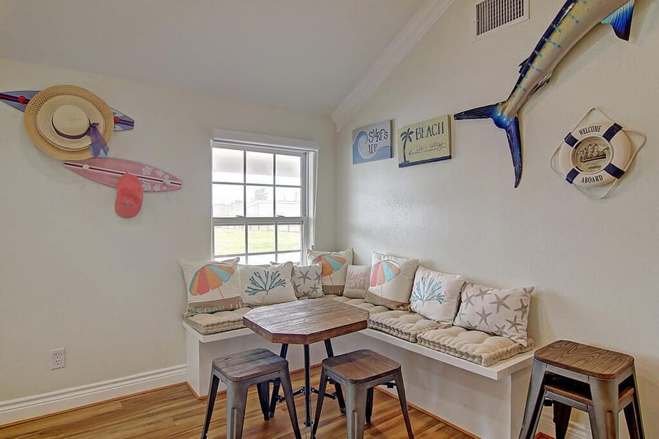 Cozy coastal nook where you'll start mornings with coffee, surrounded by charming beach décor and soft cushions for ultimate relaxation.