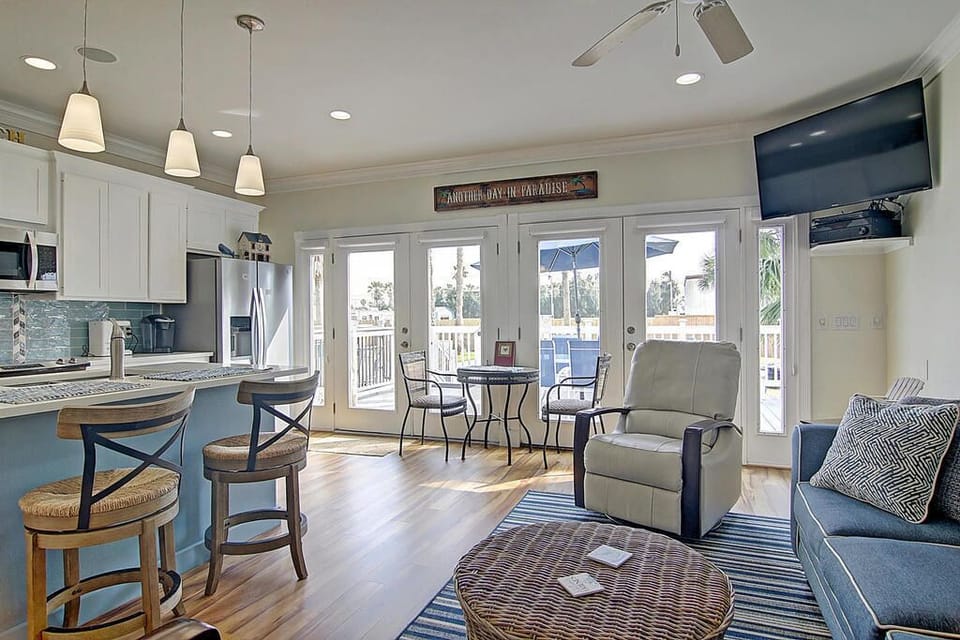 Relax in your bright open-plan space where coastal charm meets modern comfort, with French doors opening to your private deck.