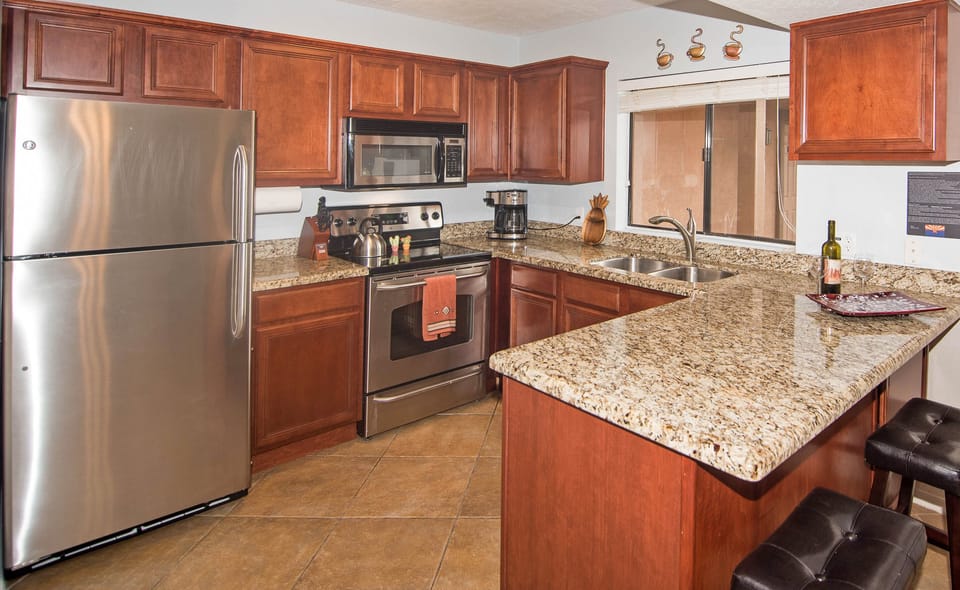 Well stocked kitchen with stove, fridge/freezer, microwave and dishwasher
