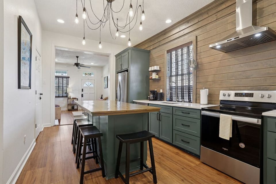 Fully equipped chef`s kitchen with butcher block island and modern appliances
