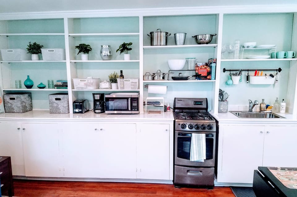 Kitchen w/spices, oil, snacks, etc. 4-burner gas stove/oven. Mini=fridge/freezer