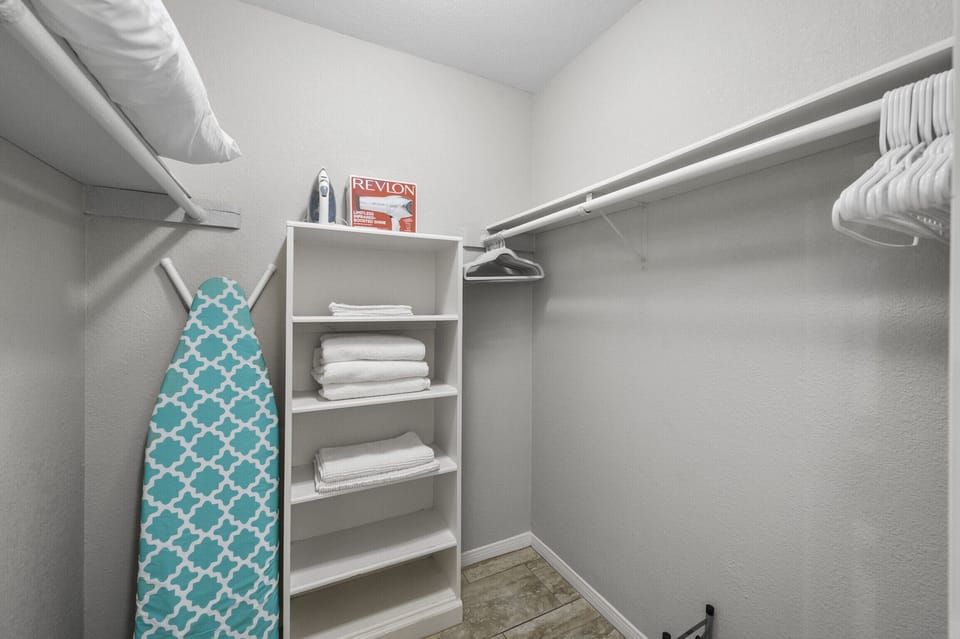A walk-in closet big enough for all your clothes. Clean with so much space!