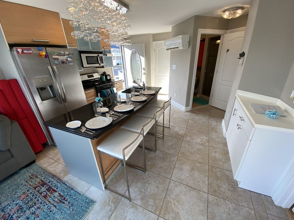 Dry bar area or standing work space. Guest bathroom and washer/dryer in closet.