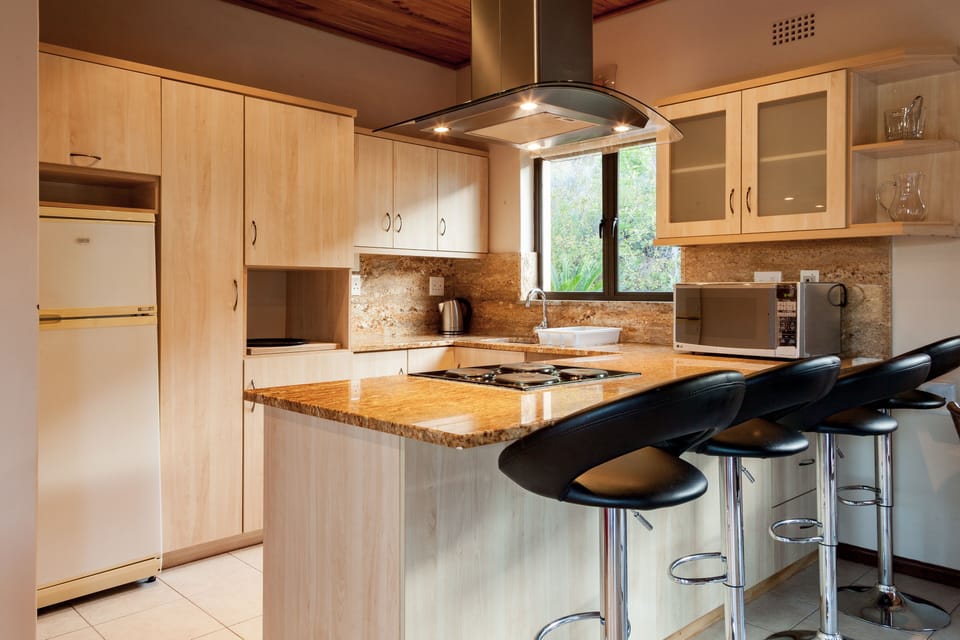 Villa | Private kitchen | Fridge, microwave, oven, stovetop