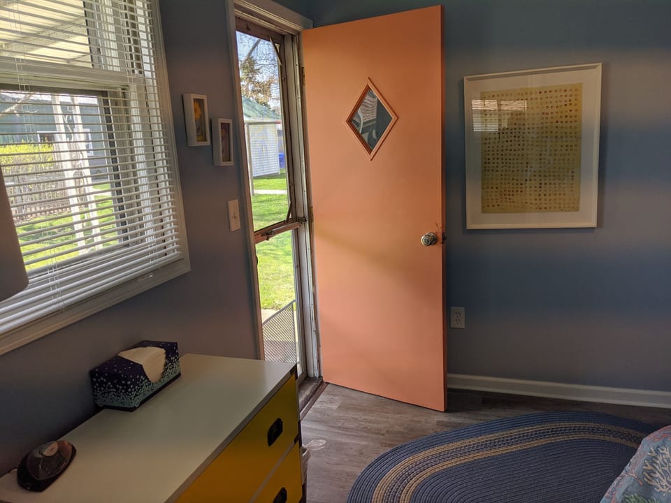 Back door leads to yard with fire pit and grill