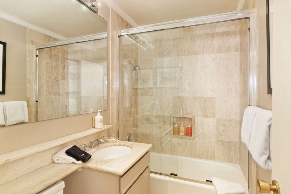 All three bathrooms in this two bedroom plus sleeping den condo have a bathtub and shower.