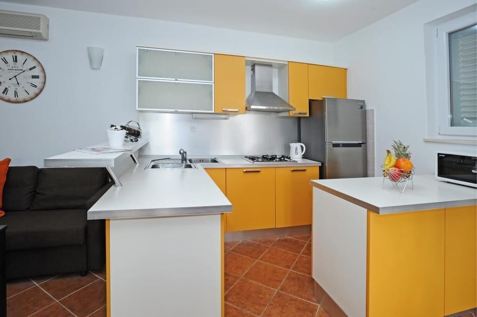 House (One Bedroom Apartment with Terrace) | Private kitchen | Fridge, oven, electric kettle, highchair