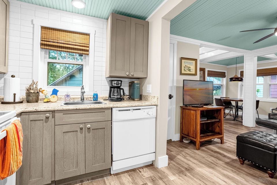 Kitchen with dishwasher, 2 coffee makers, garbage disposal and snacks.