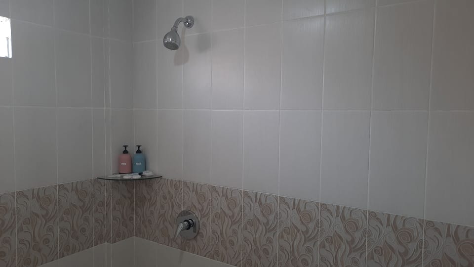 Shower, rainfall showerhead, slippers, towels