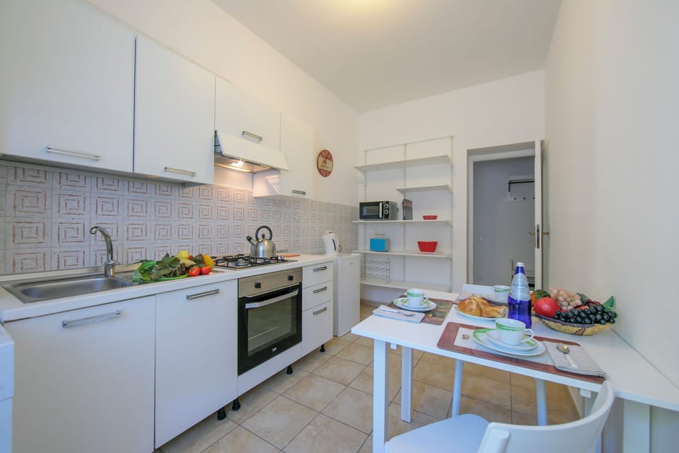 Family Apartment, 2 Bedrooms, Microwave (Casa Al Caprifoglio 600m From Beach) | Private kitchen | Fridge, microwave, oven, stovetop