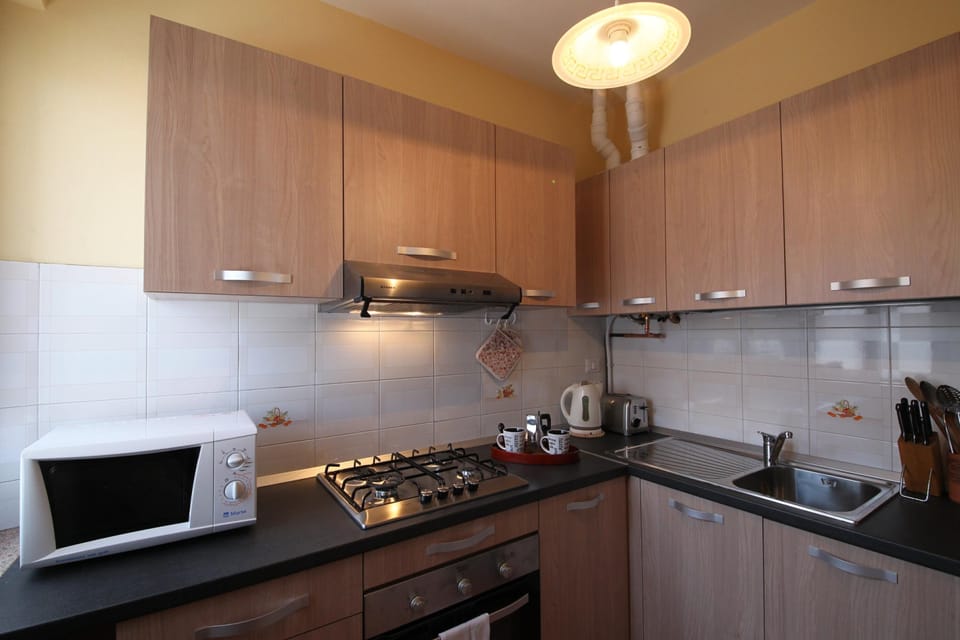 Family Apartment, Multiple Bedrooms (Sunset in Baveno) | Private kitchen | Full-size fridge, microwave, oven, stovetop