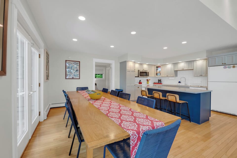 Dining area and kitchen in main room with French doors to the left