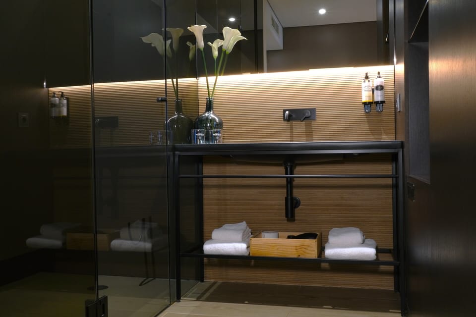 Superior Suite | Bathroom | Designer toiletries, hair dryer, bathrobes, slippers