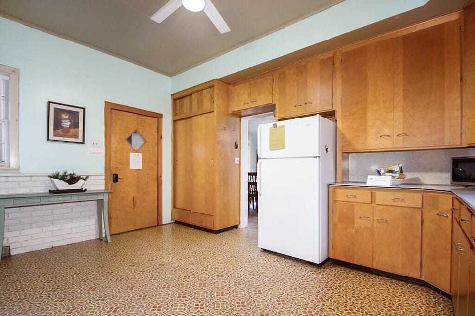 Enter into the large kitchen with full size stove and refrigerator