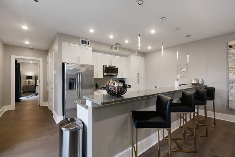 Cook and dine easily in the fully stocked kitchen, equipped with all stainless steel appliances, gas range, basic cookware, and a dining area for a comfortable meal at home. Entertain at the bar with seating for four.