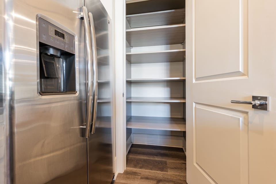 Cook and dine easily in the fully stocked kitchen, equipped with all stainless steel appliances, gas range, basic cookware, and a dining area for a comfortable meal at home. Entertain at the island with seating for four.