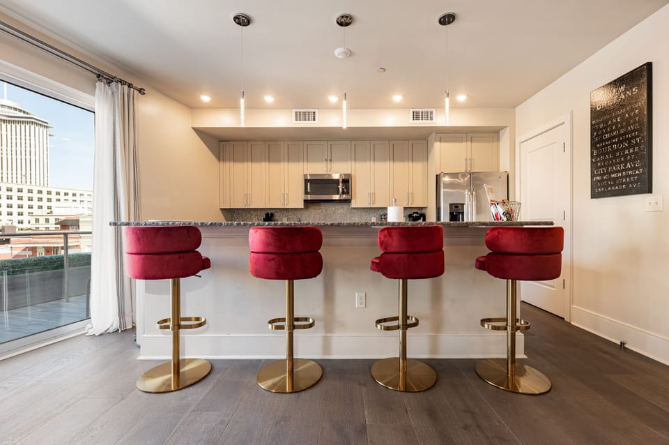 Open concept living, kitchen, and dining area with ample comfortable seating options for you and your guests. 65” Samsung Smart 4K TV that allows for streaming from your favorite apps, along with the DIRECTV Entertainment. Lounge on the sofa and cozy chairs after an activity filled day in NOLA! Dining table with seating for four and bar dining with seating for four. All the natural light too!