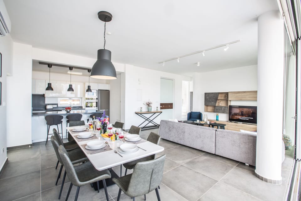 Kitchen and dining area with table and chairs to seat 8 people