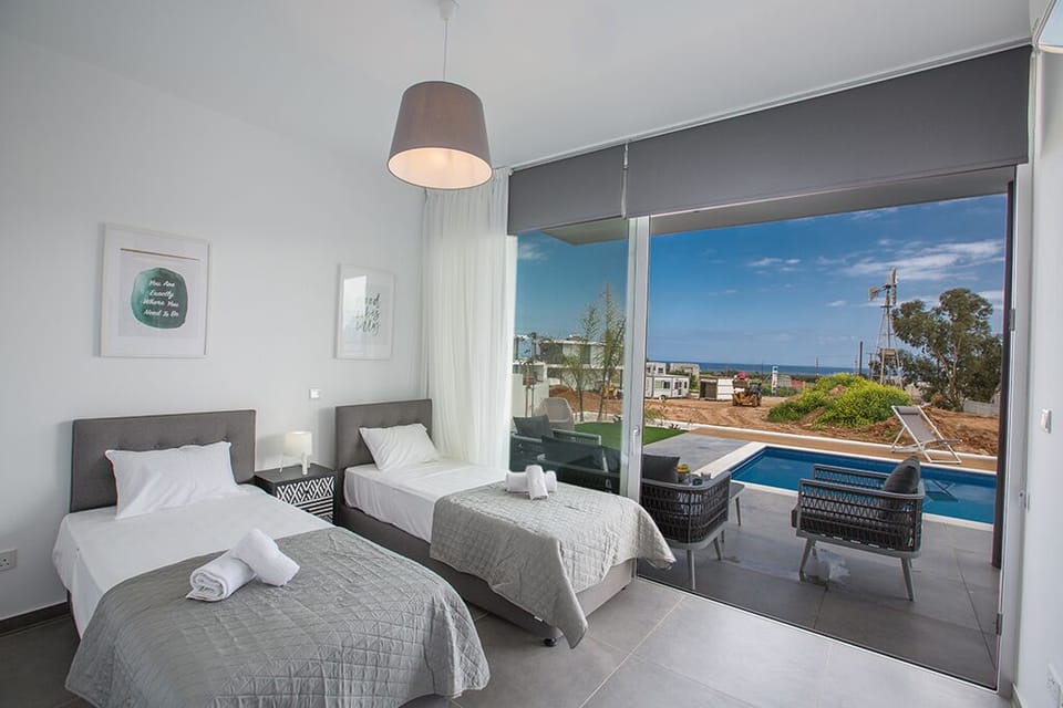 Bedroom 4, ground floor with 2 single beds and access to the garden and pool