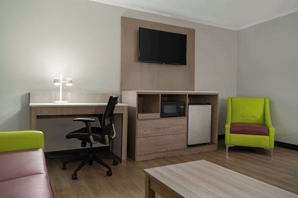 Premium bedding, desk, laptop workspace, iron/ironing board