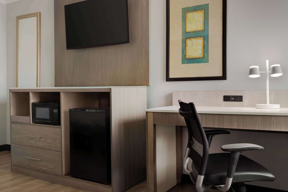 Premium bedding, desk, laptop workspace, iron/ironing board