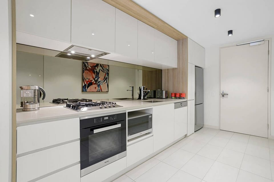 Modern fully equipped kitchen with cooking appliances, microwave, pots, pans and plenty of cooking utensils for the times you just want to stay in.